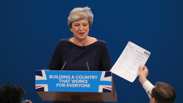 Theresa May is presented with a mock 'P45' notice of dismissal at the Conservative Party Conference in October.