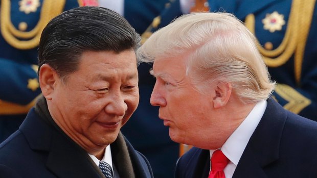 US President Donald Trump chats with Chinese President Xi Jinping during a welcome ceremony at the Great Hall of the People in Beijing in November.