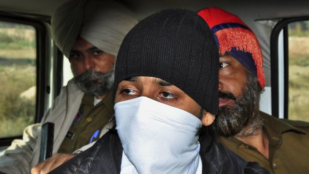 Puneet Puneet, foreground, is escorted by policemen at a district court in Rajpura, in northern India, in August last year.