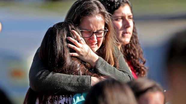 Students released from the lockdown console each other at Marjory Stoneman Douglas High School in Parkland, Florida.