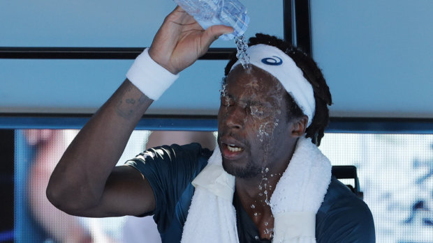 France's Gael Monfils douses himself with water due to the searing heat on court.