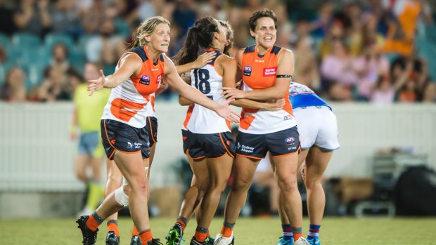 Giants players celebrate after Giants' Amanda Farrugia kicked a major late in the fourth quarter to cement a famous victory over the Western Bulldogs. Photo: Sitthixay Ditthavong
