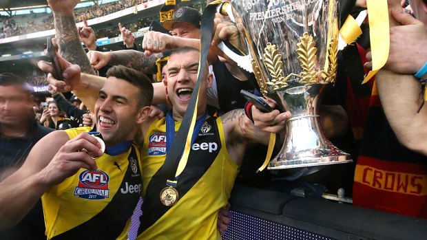 Graham hoists the cup with Dustin Martin.