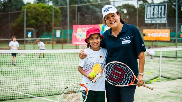 Evonne Goolagong Cawley at an indigenous tennis clinic with nin-year-old student Erica Church.