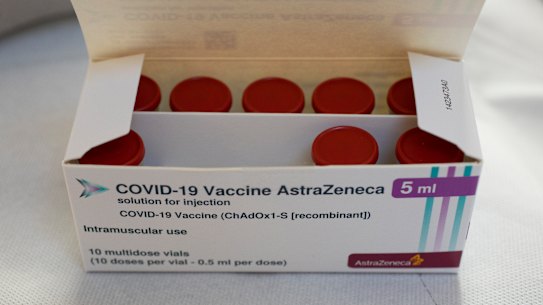 A box with vials of the AstraZeneca vaccine is taken out of a fridge for a few seconds during a vaccination campaign in Amsterdam, Netherlands. 