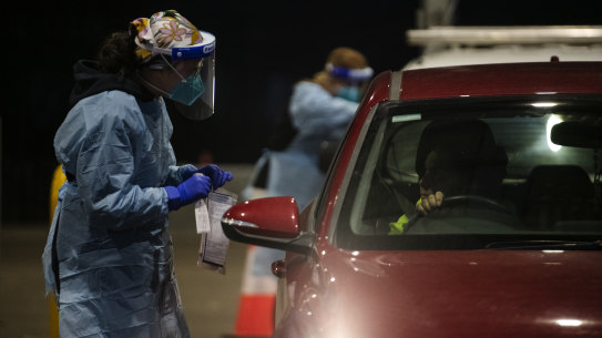 SydPath staff conduct COVID-19 tests at the 24-hour drive through clinic at Fairfield Showgrounds. 