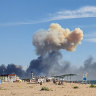 Rising smoke can be seen from the beach at Saky after explosions were heard from the direction of a Russian military airbase near Novofedorivka, Crimea.