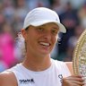 Poland’s Iga Swiatek holds the trophy after beating Amanda Anisimova to win the women’s singles final.