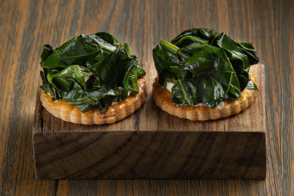 Rounds of buttery house-made pastry topped with charry broccoli leaf and curd.