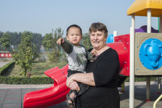 Linda Shum, 65, holds Zheng Yue, 2, near outside play equipment at Eagles’ Wings, an aid organisation founded by Shum and her late husband Greg to help abandoned, disabled and orphaned children in partnership with Chinese welfare authorities. 