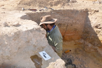 Palaeontologist Julien Louys from Griffith University examines sediment layers at the dig site.