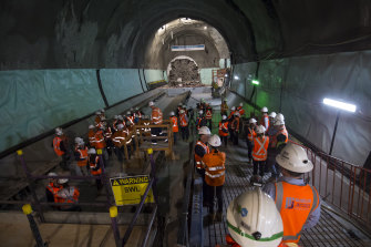Construction workers near the tunnel boring machine named Nancy, which broke through at the new Pitt Street station on Friday.