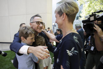 Cuddlier?: Senator Richard Di Natale embraces his children Luca and Ben and his wife Lucy Quarterman after announcing his resignation as Greens leader on  Monday.