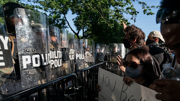 Protesters yell at military police during a demonstration in Washington, DC. 