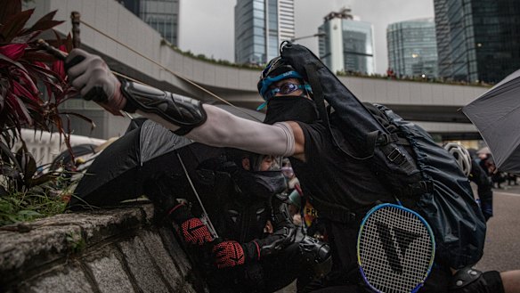 A protester uses a sling shot outside the Central Government Complex.