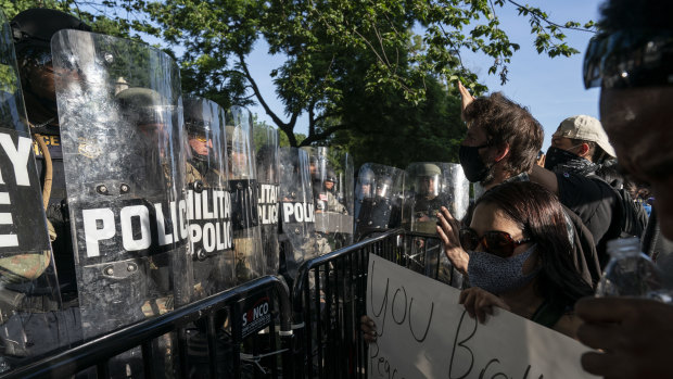 Protesters yell at military police during a demonstration in Washington, DC. 