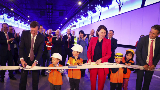 Federal Urban Infrastructure Minister Alan Tudge cuts the ribbon on the NorthConnex tunnel on Friday as NSW Premier Gladys Berejiklian and Transport Minister Andrew Constance watch on.