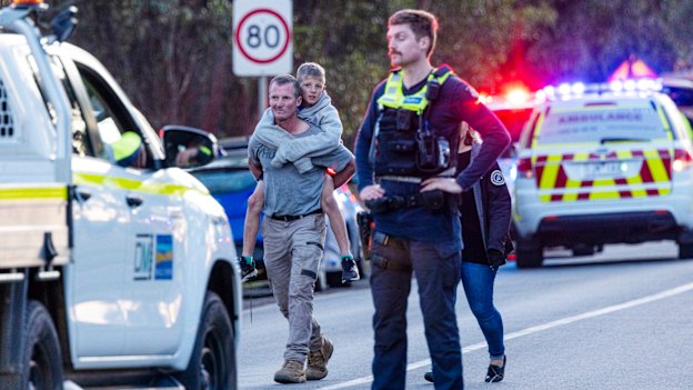 A family leaves the site of the crash, which occurred in May 2023.