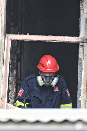 A fire investigation team inside the burnt boarding house.