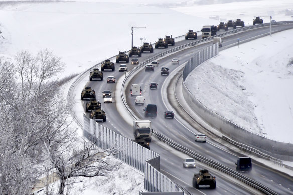 A convoy of Russian armored vehicles moves along a highway in Crimea.