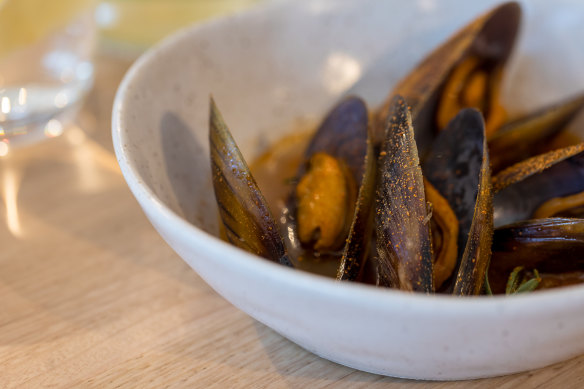 Mussels served in an umami-rich tomato water.