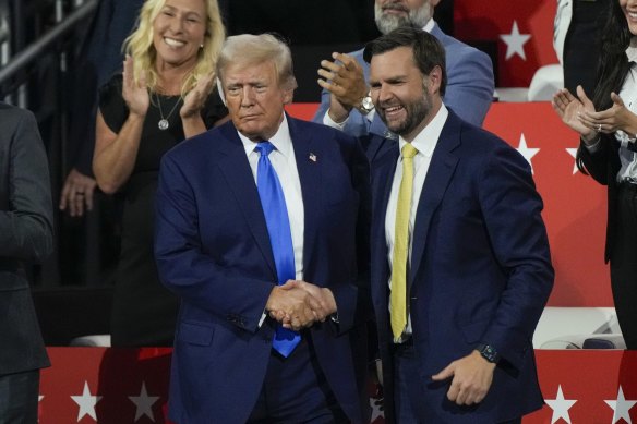 Republican presidential candidate former President Donald Trump shakes hands with Republican vice presidential candidate J.D. Vance.