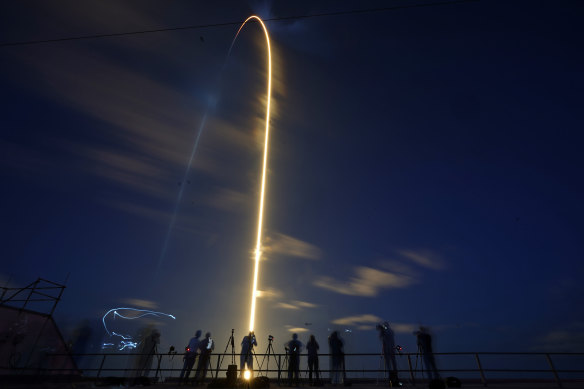 A SpaceX Falcon 9 rocket, with four private citizens onboard, lifts off in this time-exposure photo from Kennedy Space Centre’s launch pad 39-A on Thursday (AEST).