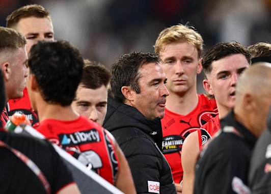 Brad Scott speaks to the Bombers players during the Richmond clash.