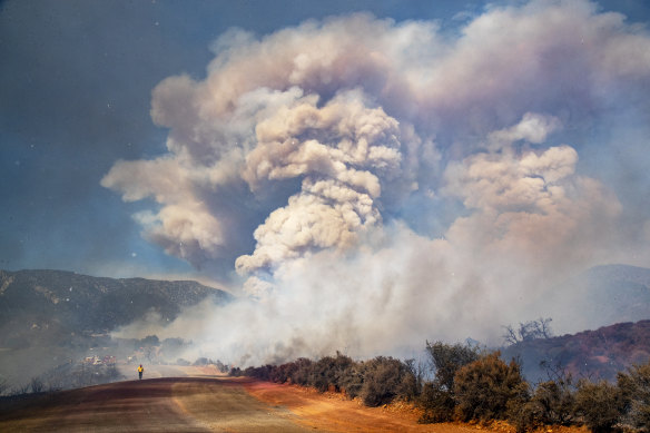 A large smoke plume fills the sky as the Apple fire burns out of control in Cherry Valley, California during August. 