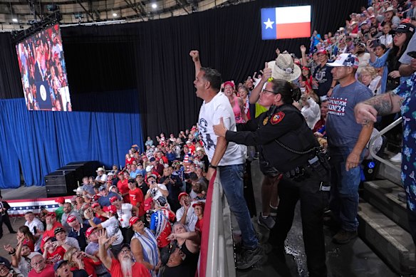 Police remove a protester as President Donald Trump speaks at a campaign rally in San Antonio on Wednesday.