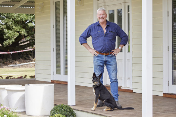 Scott Cam in front of the renovated farmhouse. 