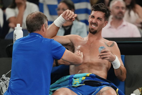 Thanasi Kokkinakis receives treatment during his second round match.