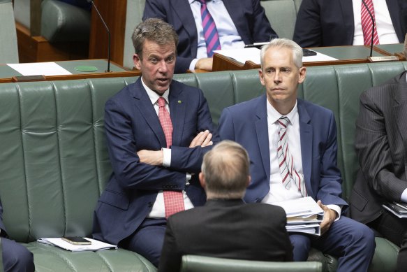 Opposition immigration spokesman Dan Tehan (left) and Immigration Minister Andrew Giles discuss the bill with Prime Minister Anthony Albanese (facing away from camera) on Tuesday.