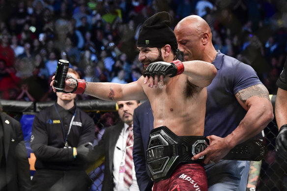 Masvidal is presented with the 'BMF' title by Dwayne 'The Rock' Johnson.