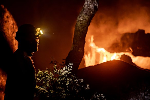 A firefighter monitors flames in La Adrada, in Spain’s Avila province.