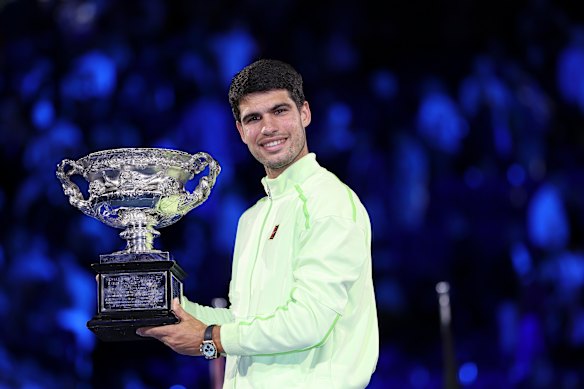Carlos Alcaraz holds his trophy.