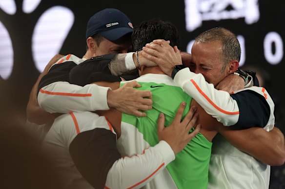 Carlos Alcaraz hugs the members of his team following his Australian Open.