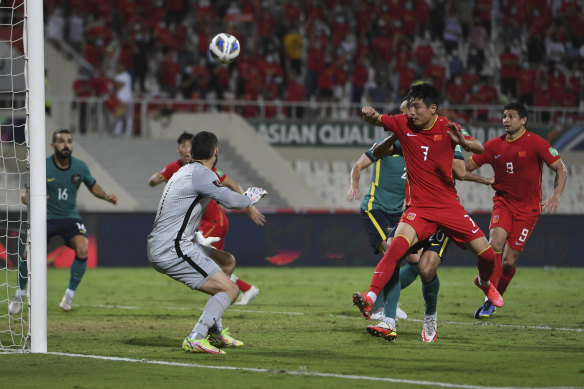 Wu Lei heads the ball during the game in the United Arab Emirates.