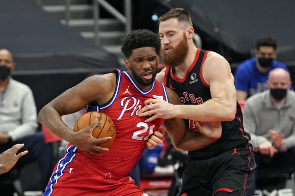 Aron Baynes (right) in action for the Toronto Raptors against Philadelphia 76ers centre Joel Embiid.