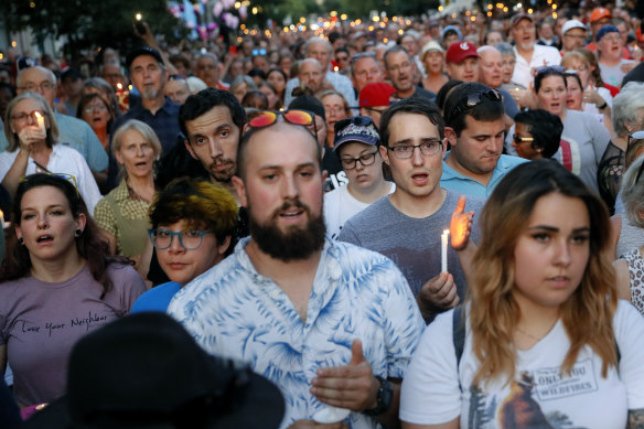 Mourners sing at a vigil in Dayton, Ohio. 