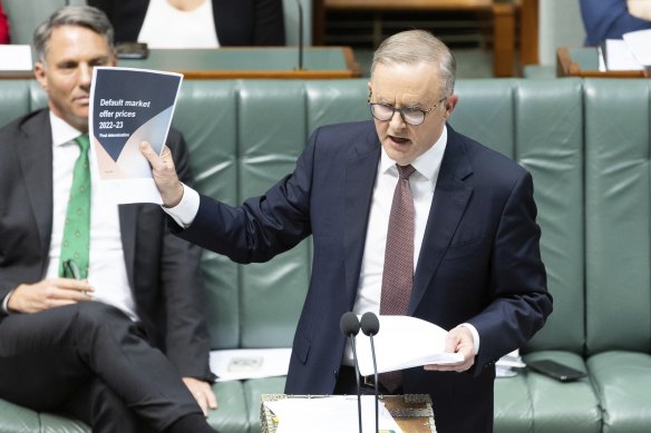 Prime Minister Anthony Albanese holds up documentation referring to energy pricing during question time today.