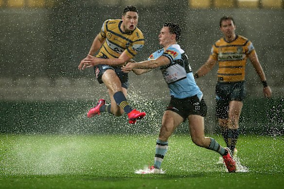 Parramatta playmaker Mitchell Moses gets a kick away in monsoonal conditions at Jubilee.