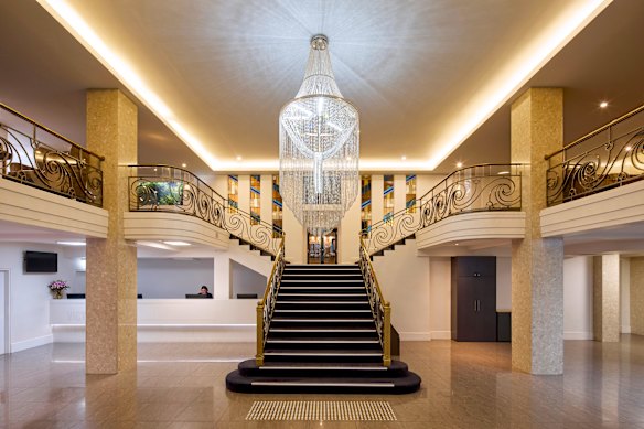 The Victoria’s impressive chandelier and a central staircase.