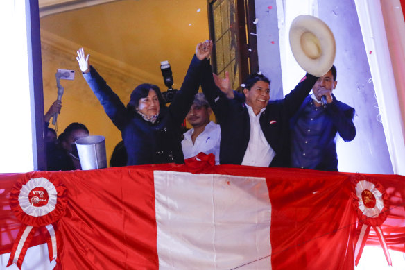 Better days: Pedro Castillo waves at supporters with his running mate Dina Boluarte after being confirmed as president last year. 