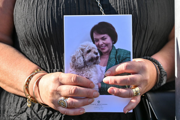 A woman holds the order of service.