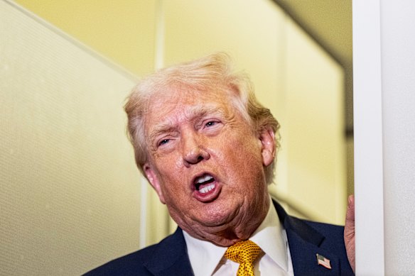 Donald Trump speaks with reporters aboard Air Force One.