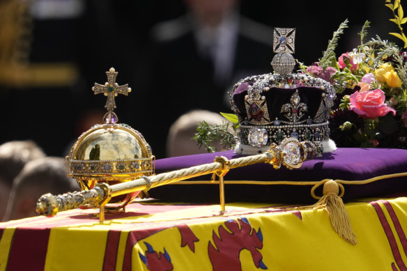 The orb, the sceptre and the crown atop the royal coffin as it leaves Westminster Abbey. 