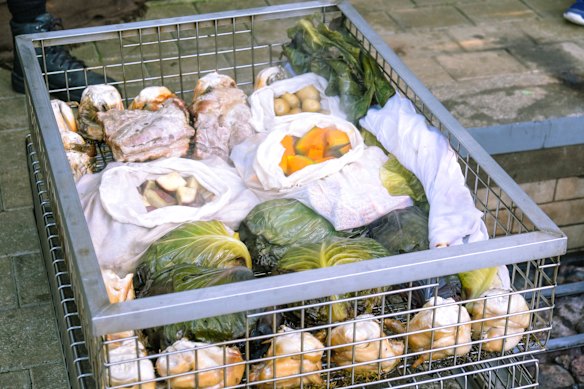 Meat and vegetables are packed in wire baskets and buried under hot rocks.