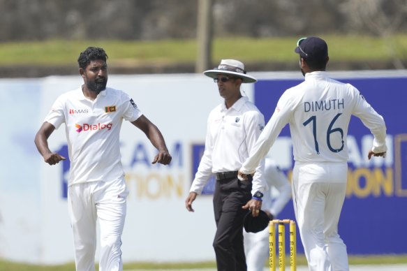 Prabath Jayasuriya, left, celebrates taking the wicket of Alex Carey during the second day of the second Test between Australia and Sri Lanka in Galle.