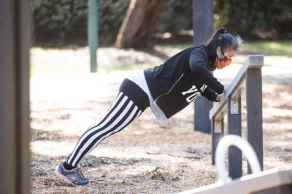 A woman works out on some outdoor gym equipment in Bentleigh.